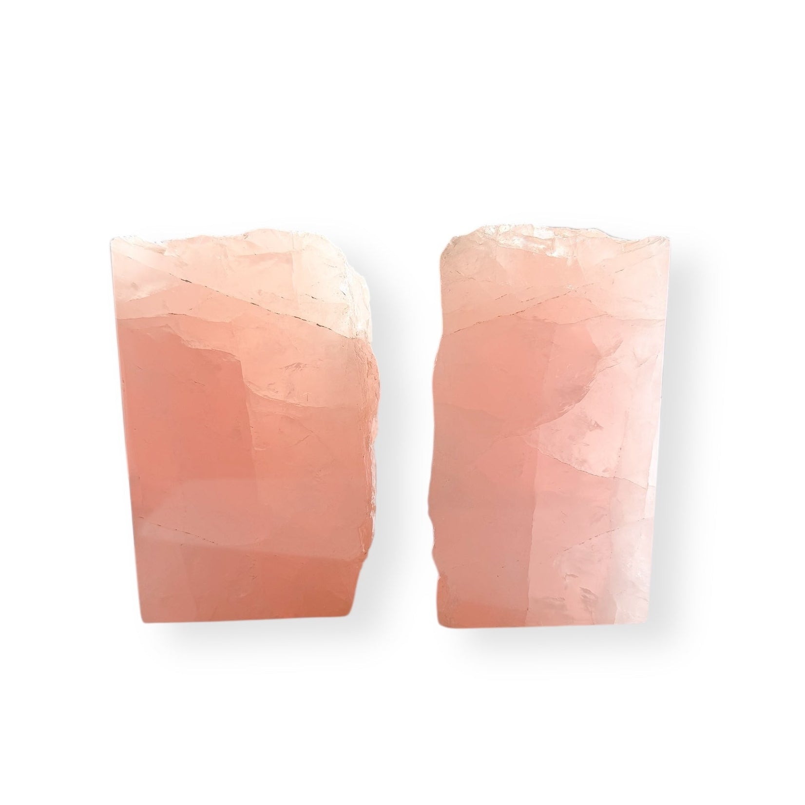 Side view of Rose Quartz bookends showing polished front and raw matte back.