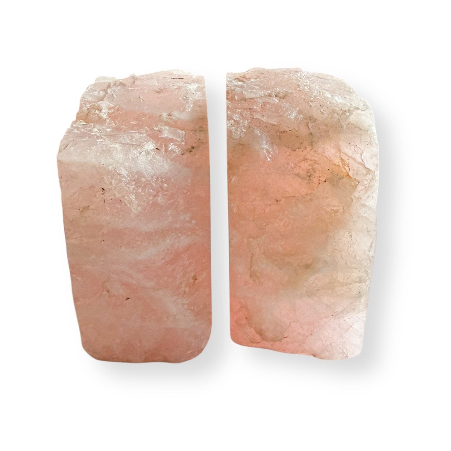 Close up detail of rose quartz bookends highlighting polished surface and natural inclusions.