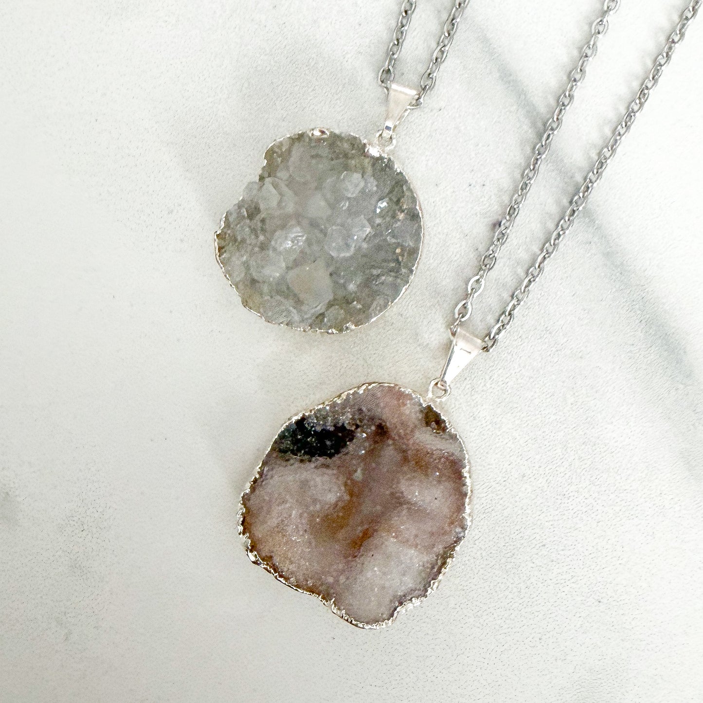 Detail view of round drusy silver plated pendant necklace highlighting organic crystal formation