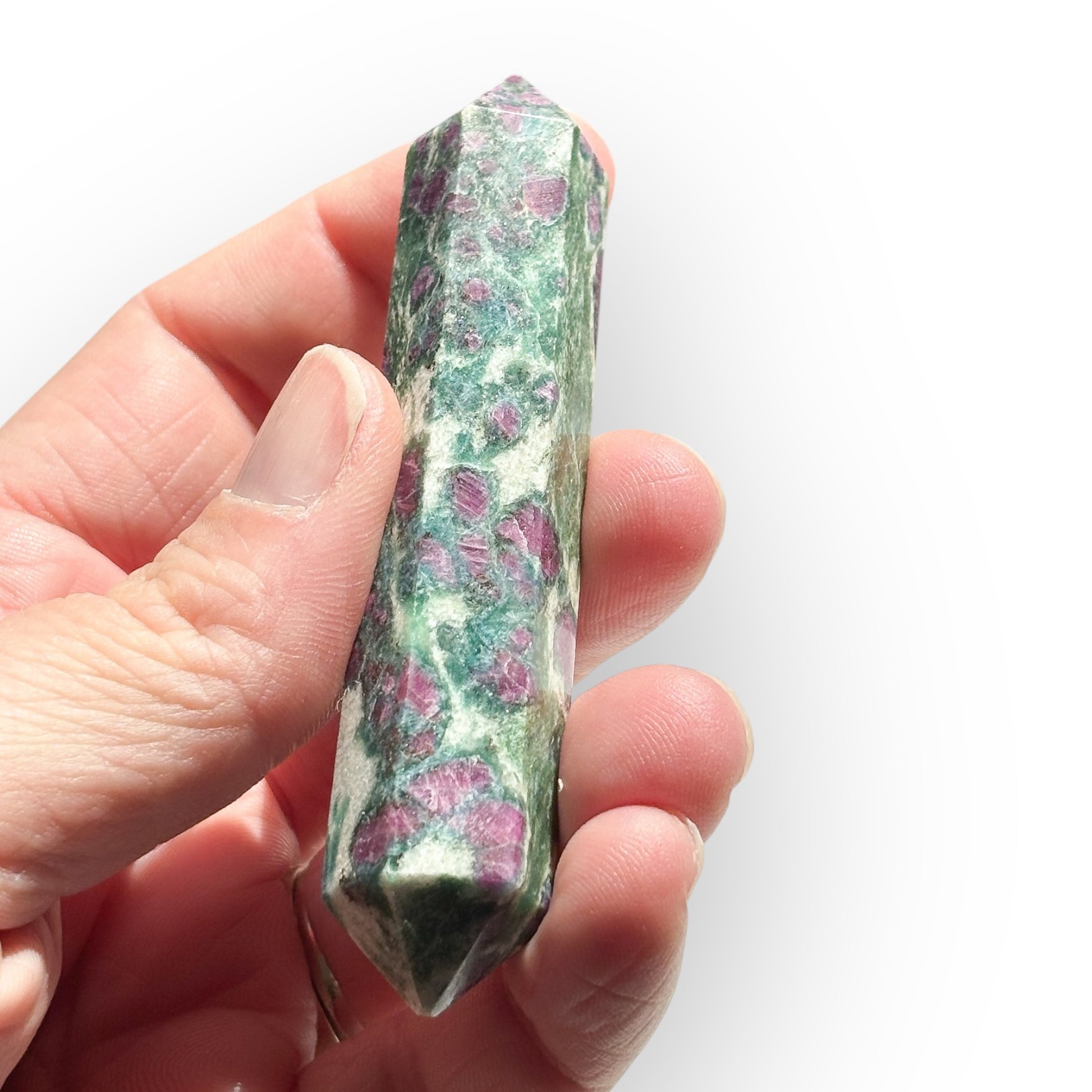 Close-up of Ruby in Zoisite Double Terminated Wand held in hand for scale and detail.