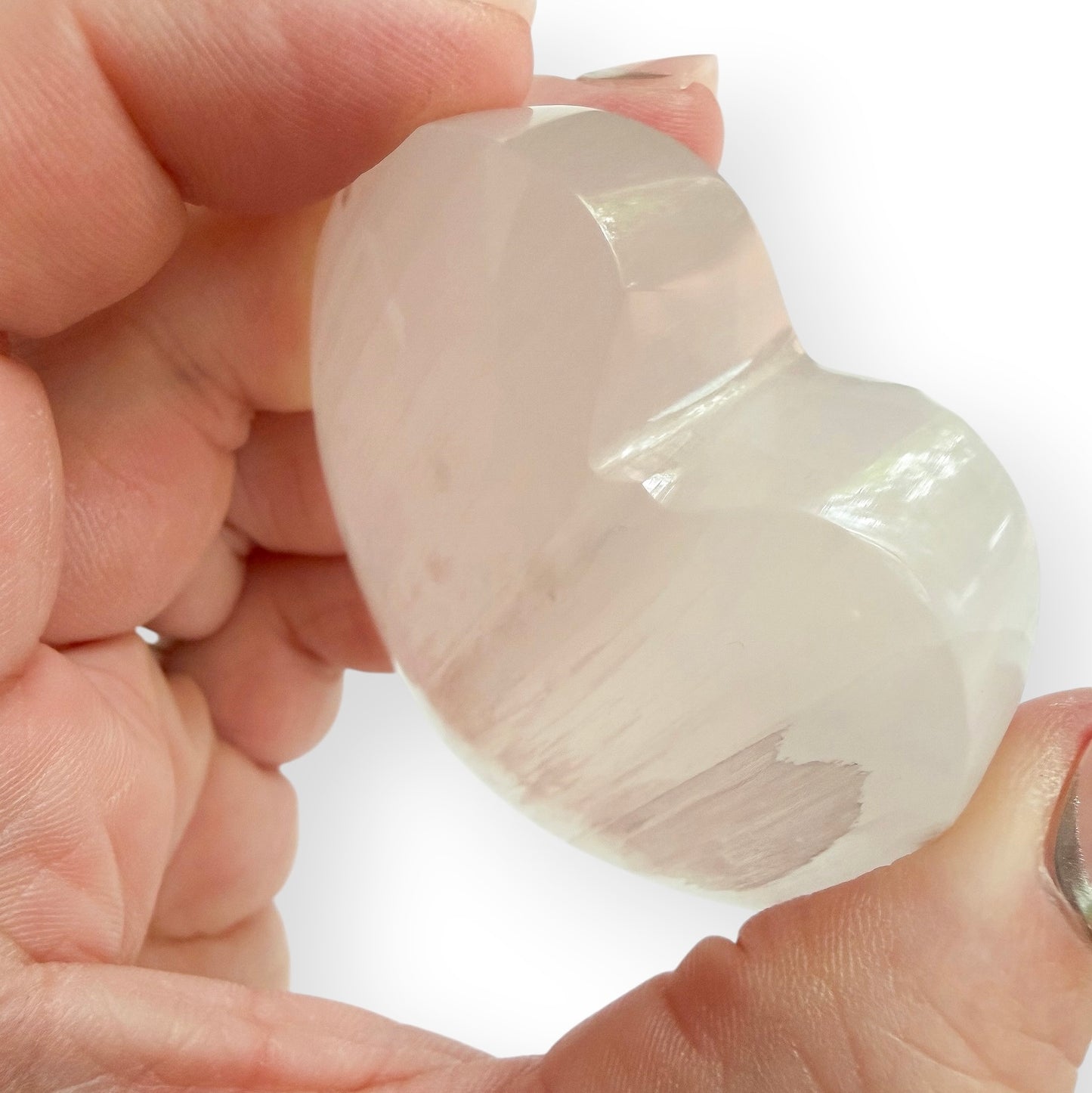 Side view of a Satin Spar heart displaying the stone’s natural fibrous texture and silky luster.