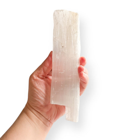 Satin Spar Selenite wand held in hand to show size and shape