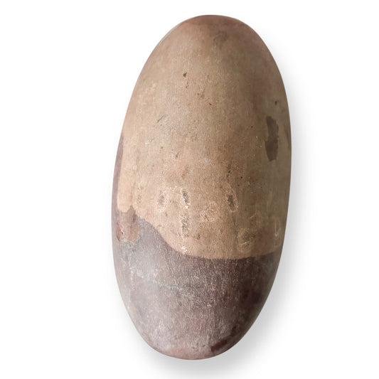 Shiva Lingam Stone A with deep brown striations and smooth surface, naturally shaped by the Narmada River.