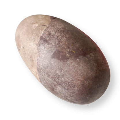 Natural Shiva Lingam Stone A displayed, showing its earthy brown and taupe tones.