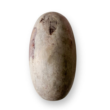 Closeup of Shiva Lingam Stone B showing smooth, polished texture and flowing natural patterns.