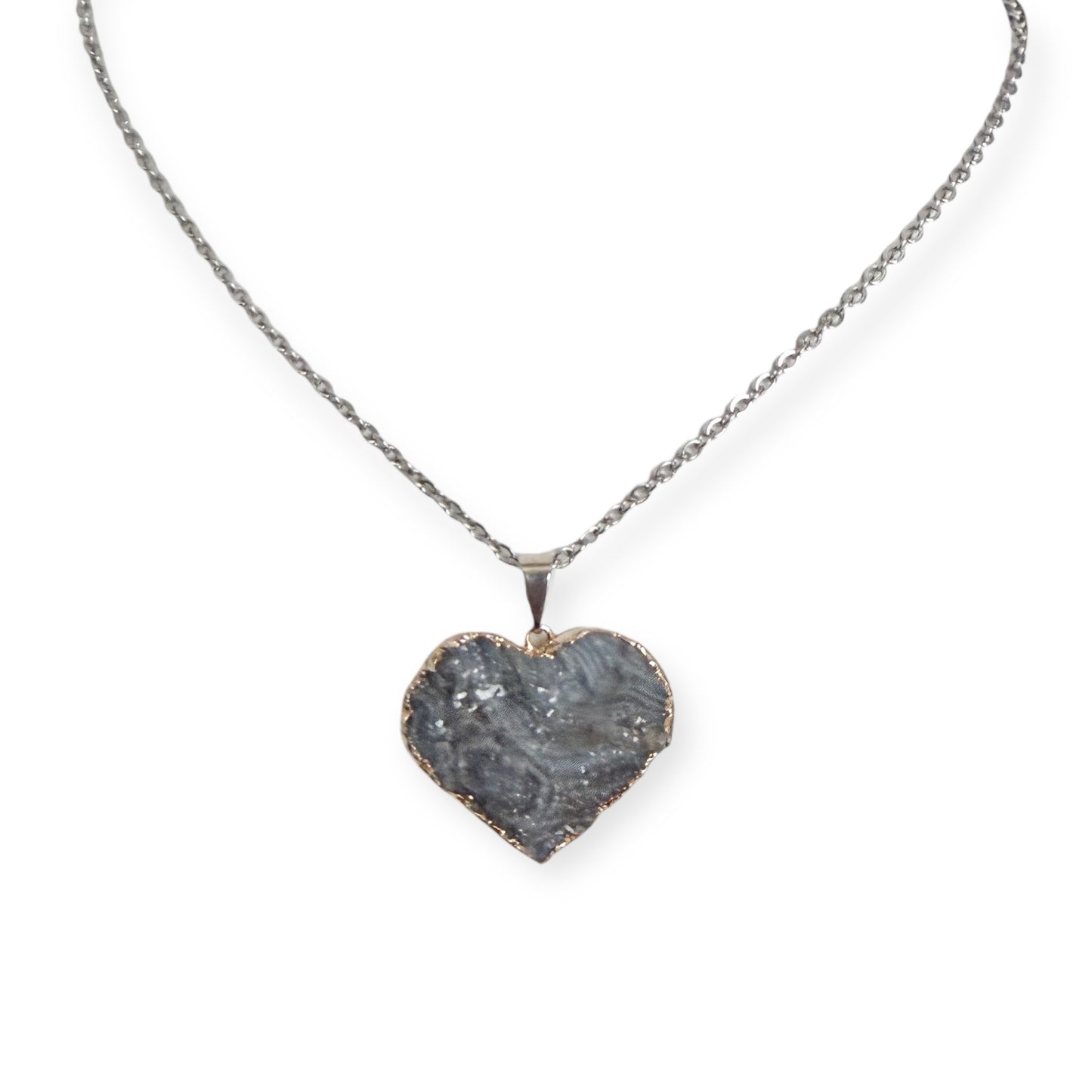 Silver plated heart drusy pendant necklace with gray crystal tones on a stainless steel chain, showing natural tarnish near the edges.