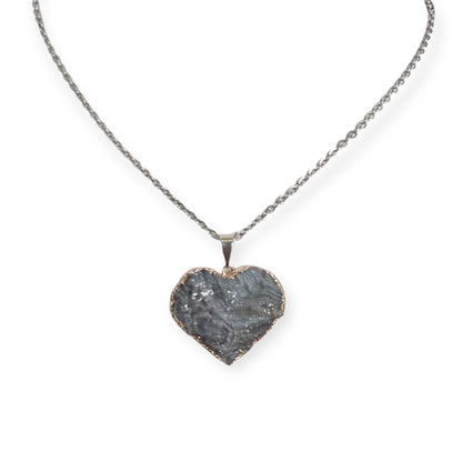 Silver plated heart drusy pendant necklace with gray crystal tones on a stainless steel chain, showing natural tarnish near the edges.