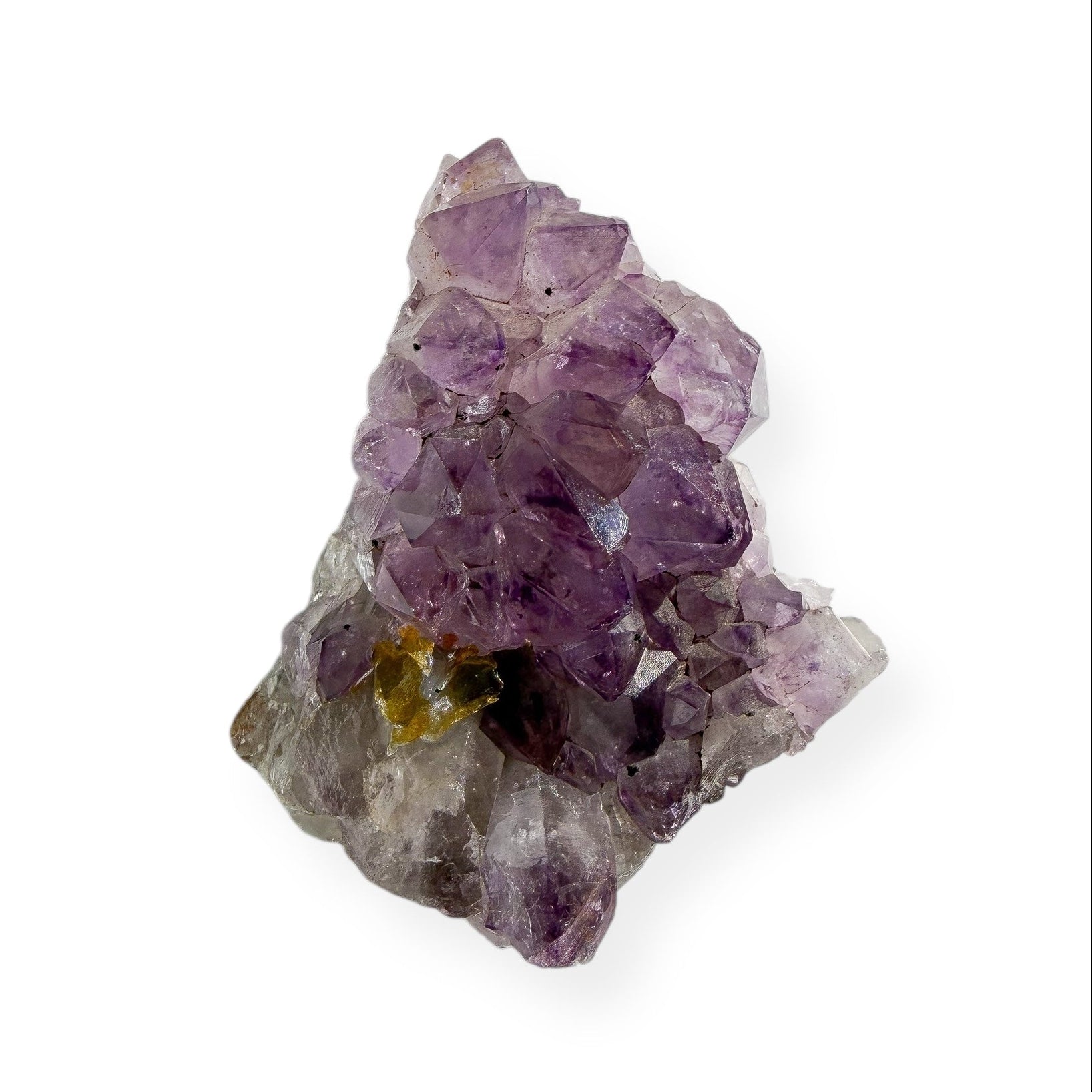 Small amethyst cluster with purple crystal points on natural matrix base