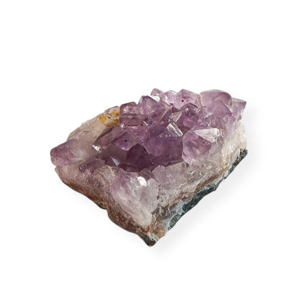 Close-up of small amethyst crystal cluster with deep violet points and raw edges