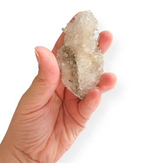 Hand holding small Clear Quartz Cluster to show size and shape