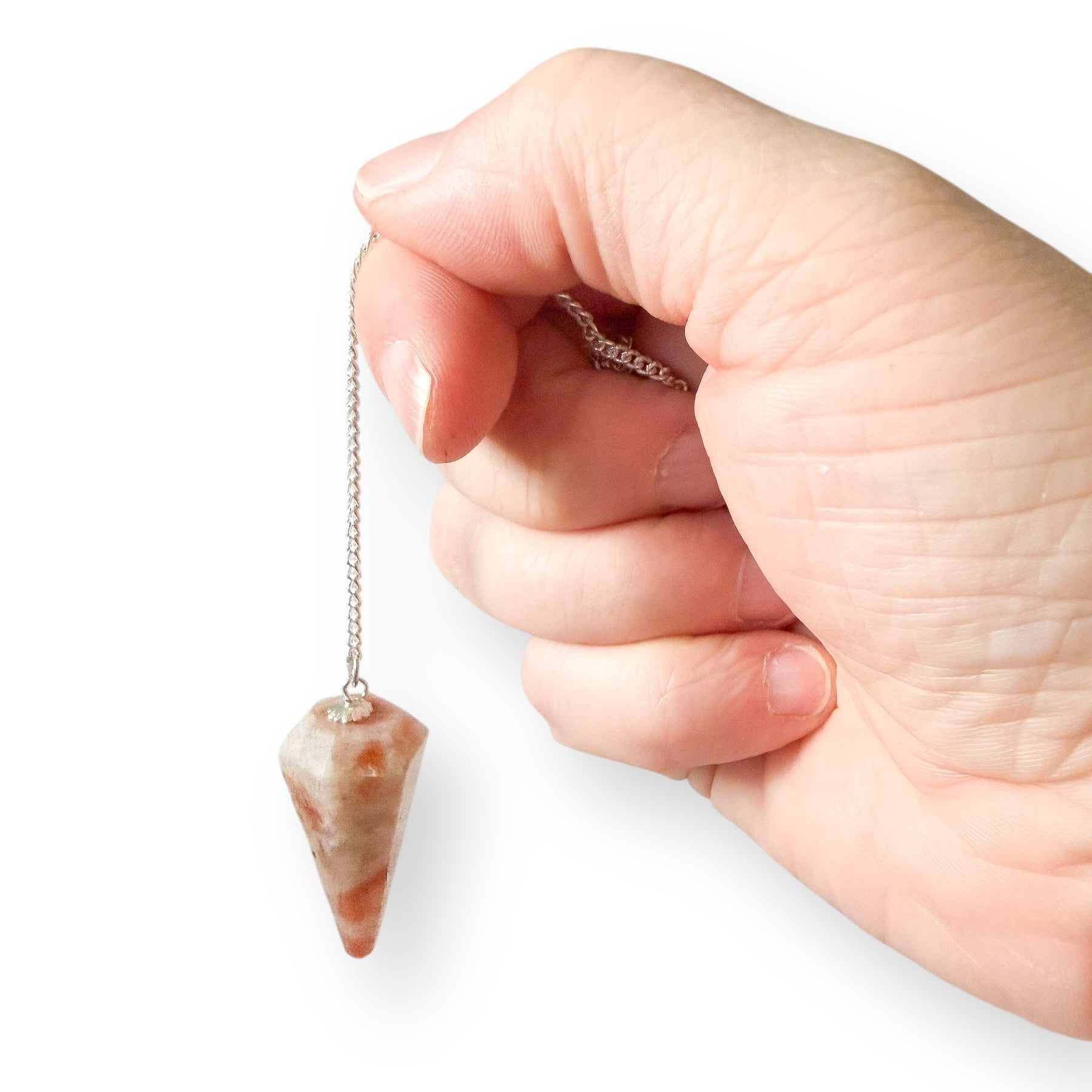 Sunstone crystal pendulum hanging from a silver chain used for intuition, confidence, and decision making