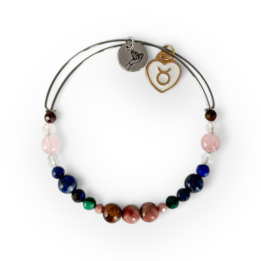 Taurus Crystal Charm Bracelet with a white charm, handcrafted with Rhodonite, Malachite, Lapis Lazuli, Clear Quartz, Rose Quartz, and Tiger’s Eye for strength and balance.