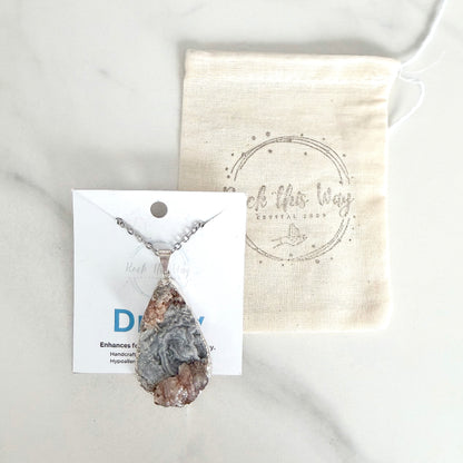 Silver plated teardrop drusy pendant necklace displayed on Rock This Way Crystal Shop packaging with included polishing cloth.