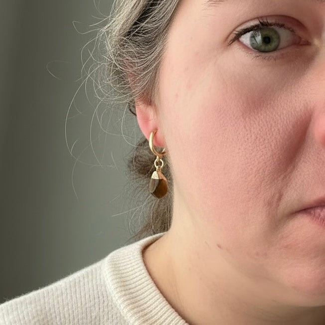 Woman wearing Tiger’s Eye drop huggie earrings with gold filled hoops for everyday wear