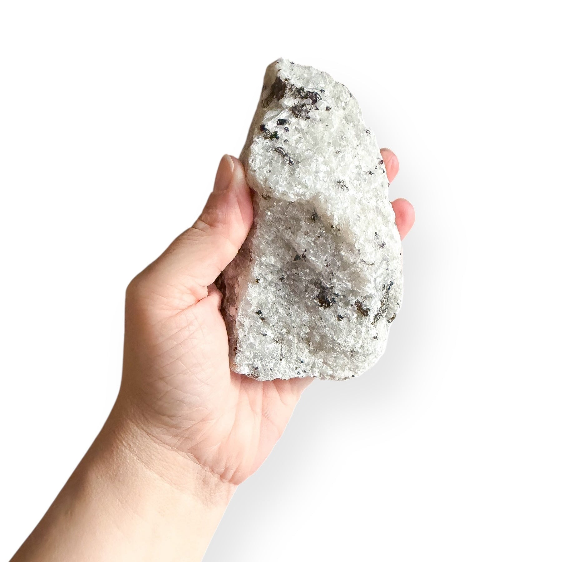 Raw Tourmalinated Quartz crystal shown in hand for size and texture