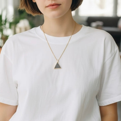 Modeled view of a gold plated triangle drusy pendant necklace on a PVD gold plated stainless steel chain, shown in an AI generated lifestyle image.