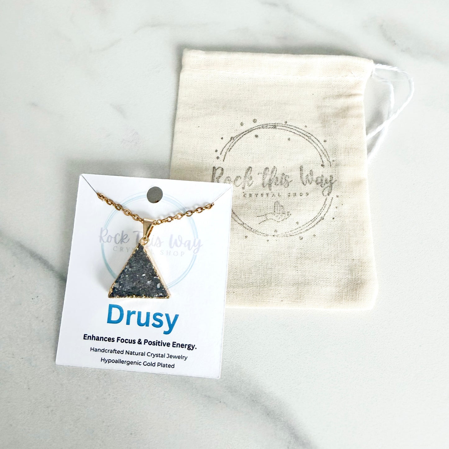Gold plated triangle drusy pendant necklace displayed on Rock This Way Crystal Shop packaging, ready for gifting.