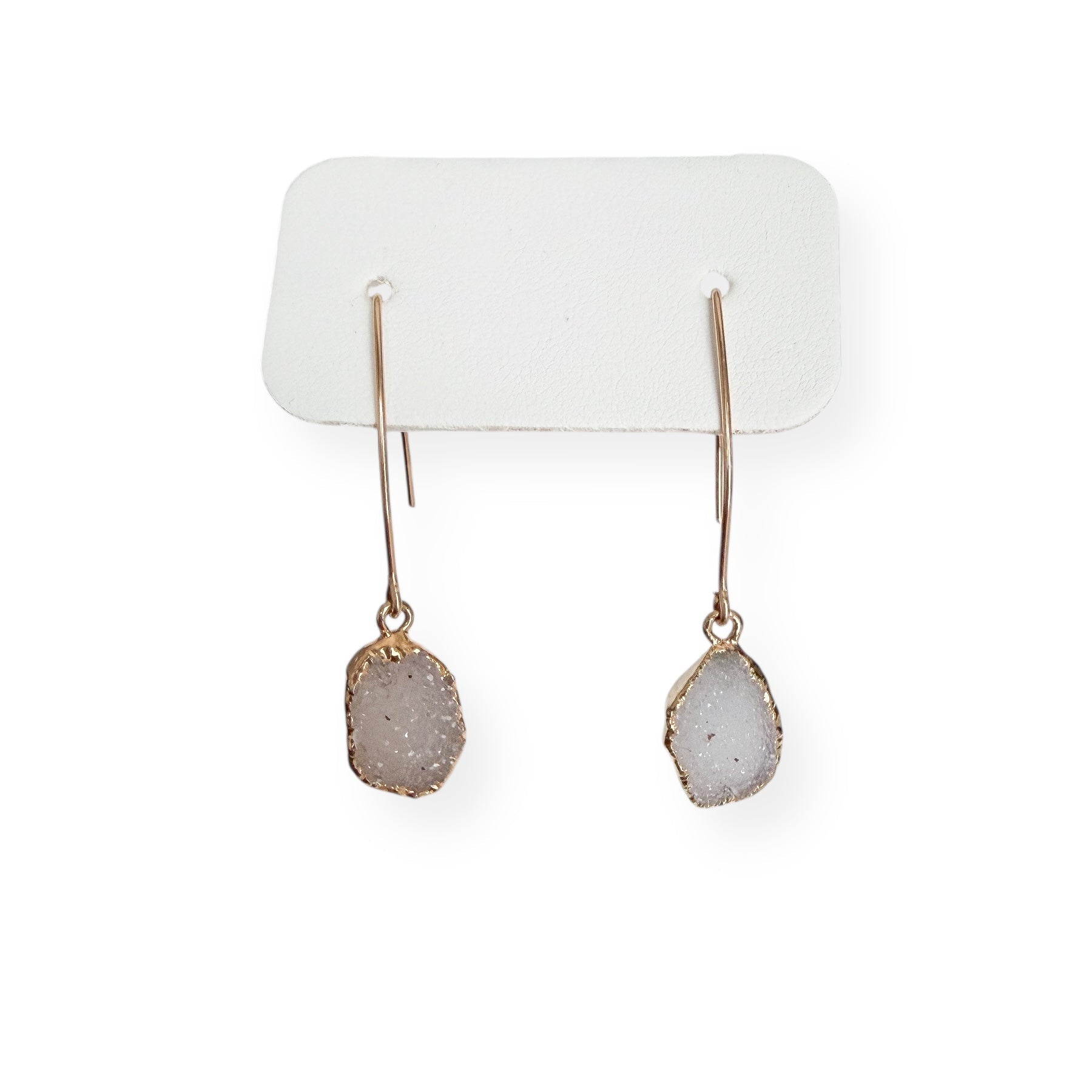 Close-up of white freeform drusy crystal earrings showing natural sparkle and organic crystal texture