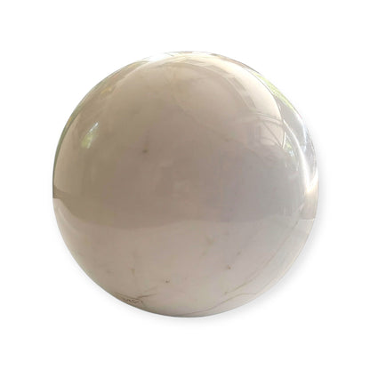 Close-up of polished white marble sphere with subtle stone lines