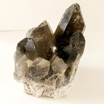 Close-up angled view of Smoky Quartz Cluster showing layered crystal points